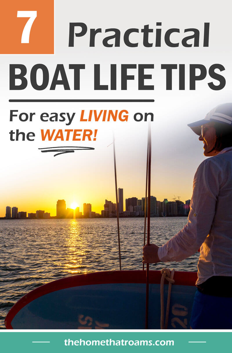 pin of woman on anchored boat looking at city skyline from the water