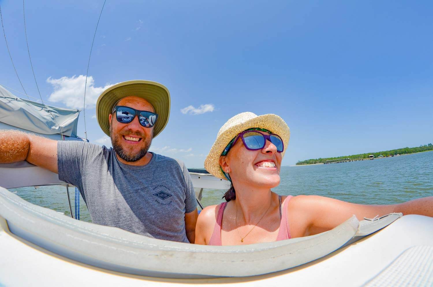 Ross and Morgan at the helm on a sailboat.