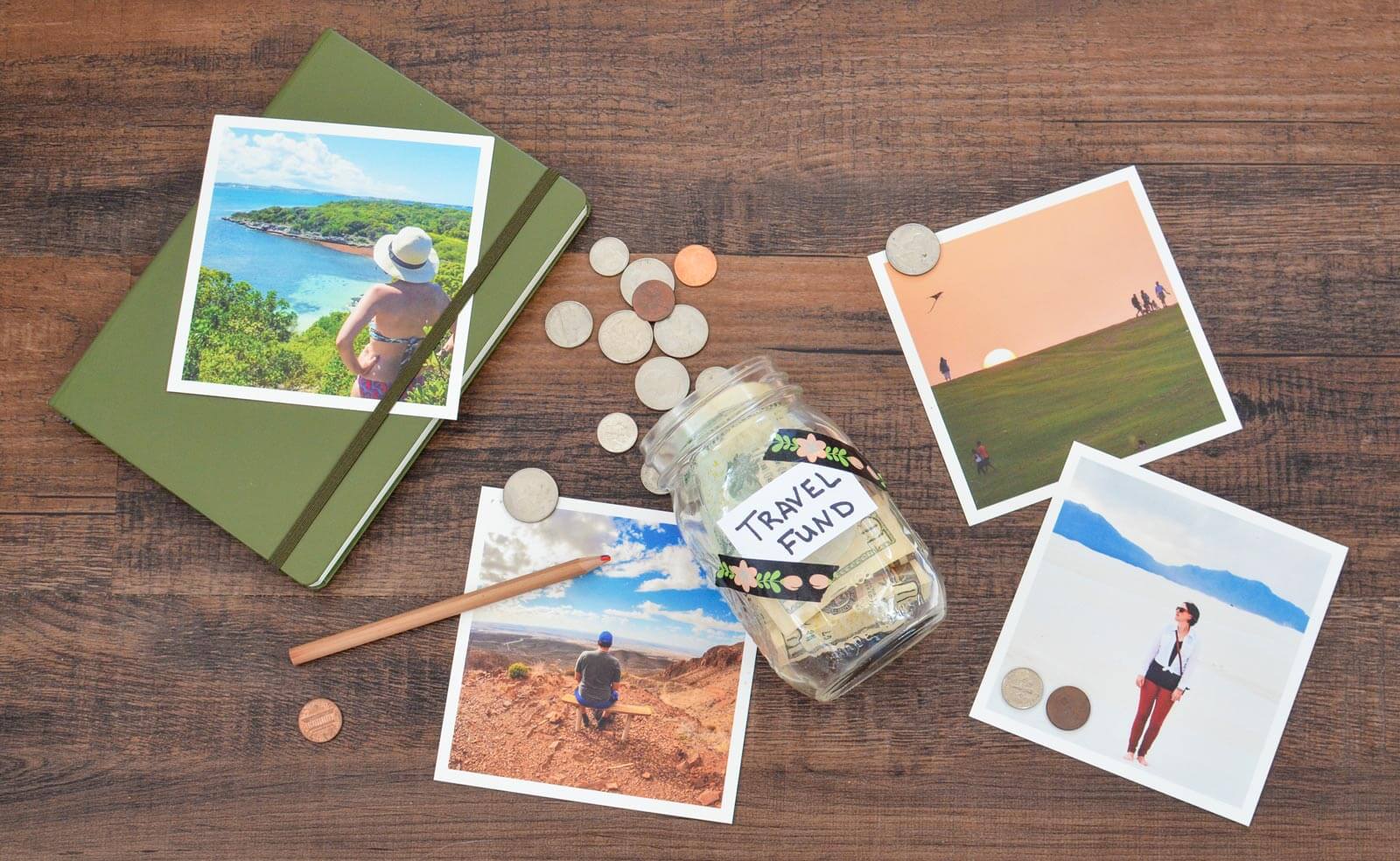 jar with money for travel fund spilling out across the floor filled with travel photos and travel journal