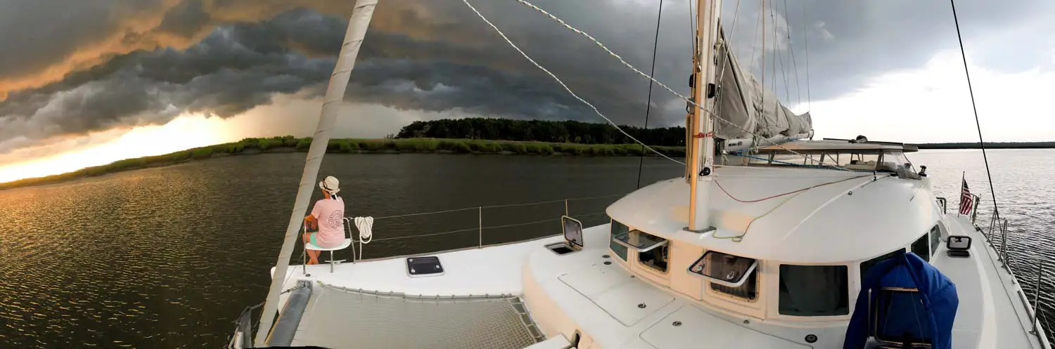 storm clouds surrounding catamaran at anchor