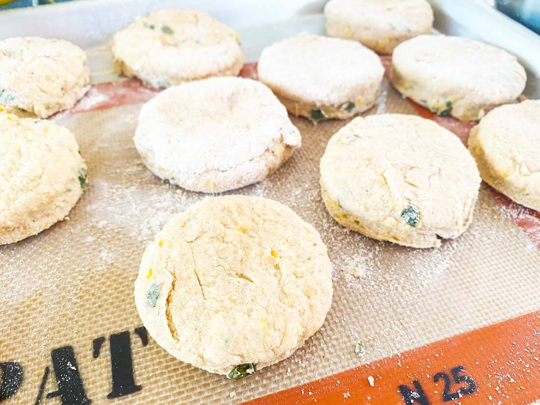 uncooked biscuits on silicone baking mat