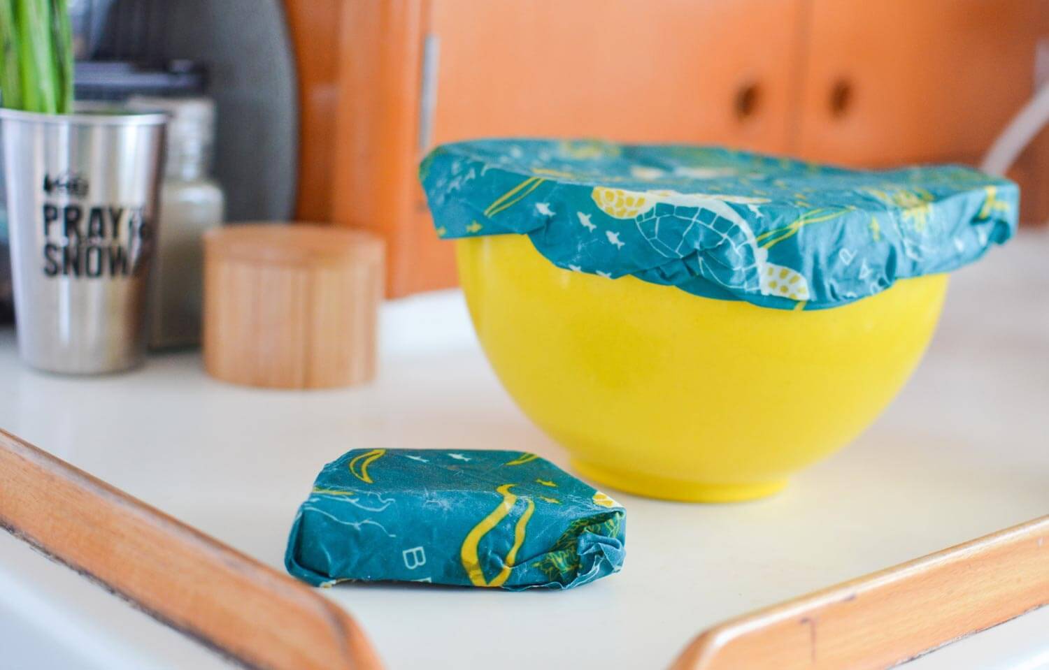 bees wax wraps covering serving bowl and wrapping up a wedge of cheese