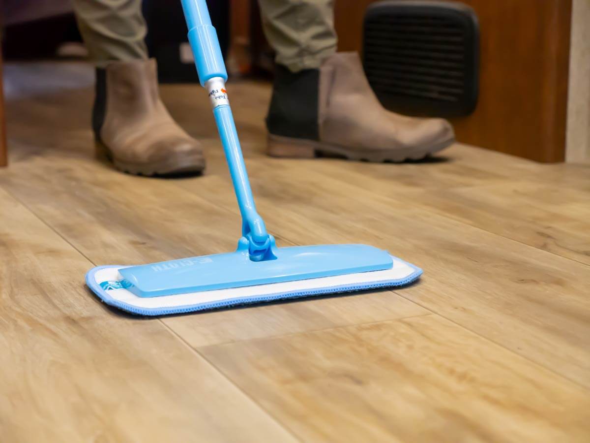 mopping floor with small mop with washable head