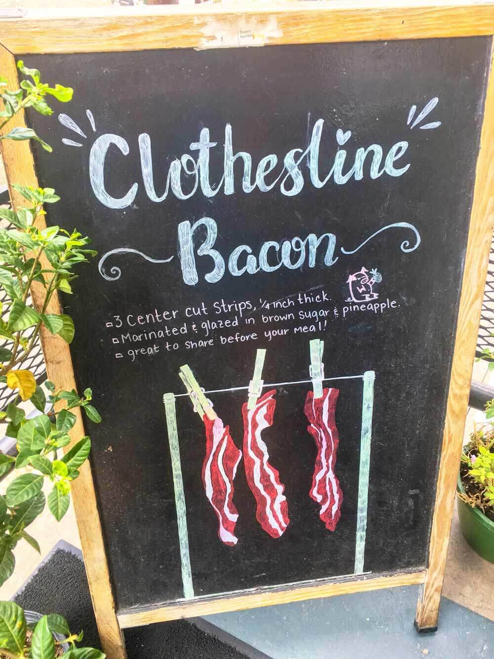 sign at 2 Cracked Eggs in downtown Savannah advertising "clothesline bacon"