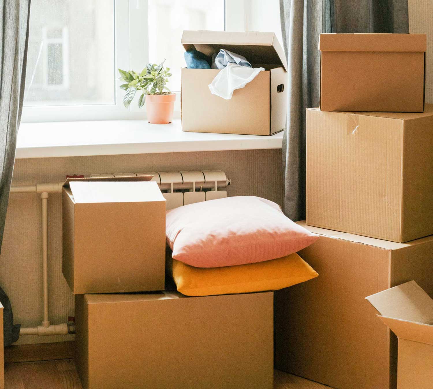 Various moving boxes on the floor in an apartment