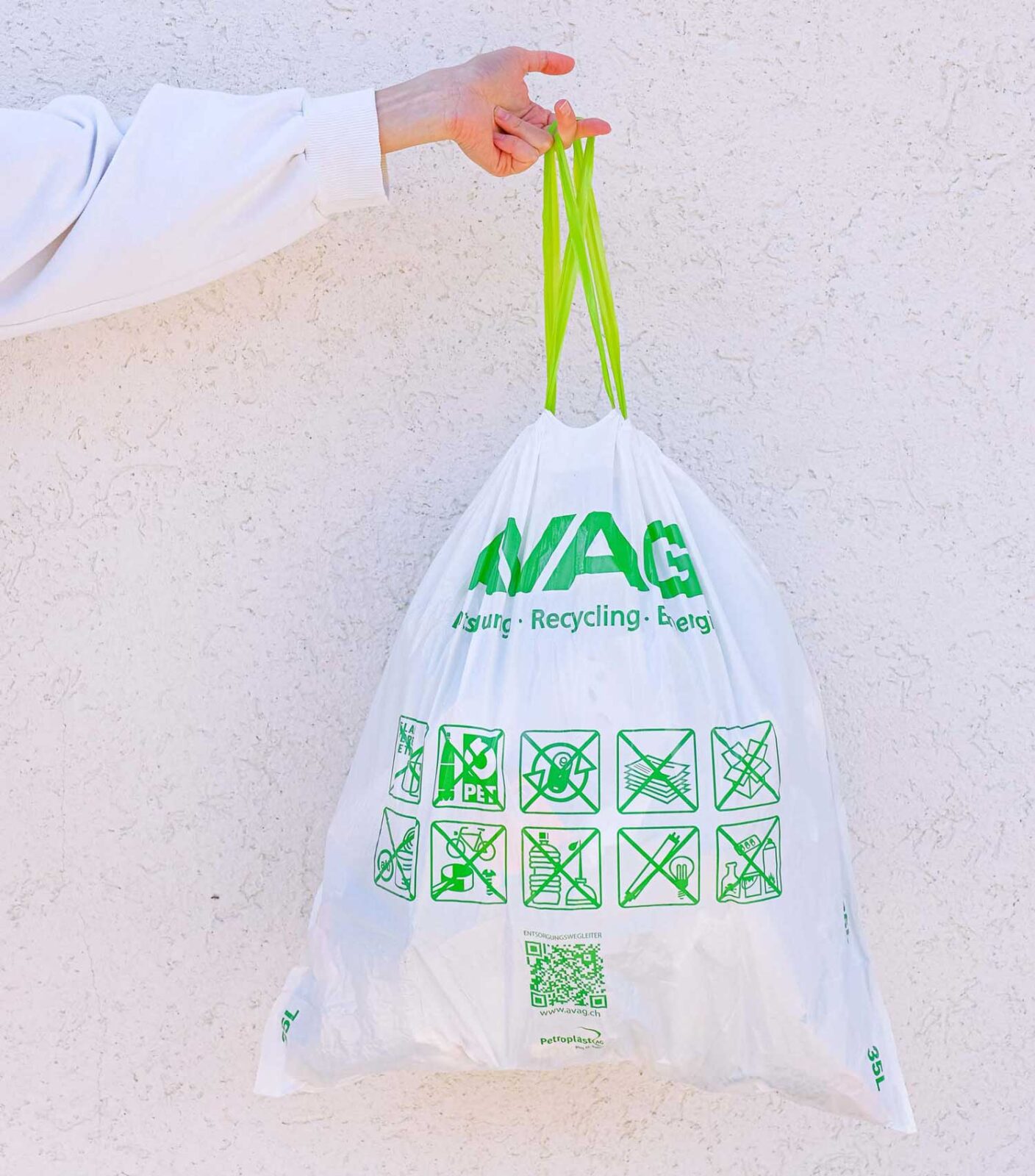 Person holding a full recycling bag