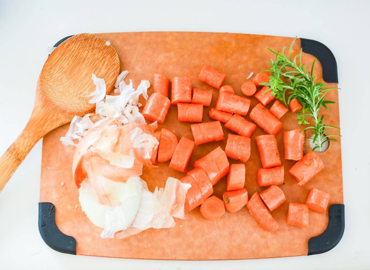 chopped vegetables included garlic and carrots on a cutting board