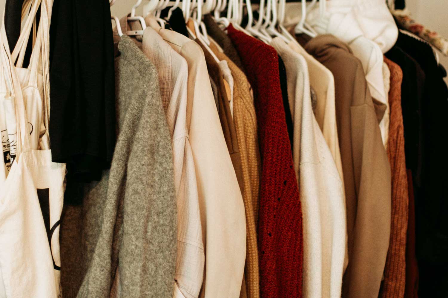sweaters hanging in closet