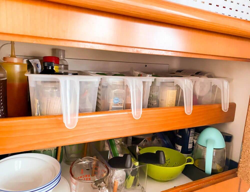 storage baskets in sailboat galley cabinet