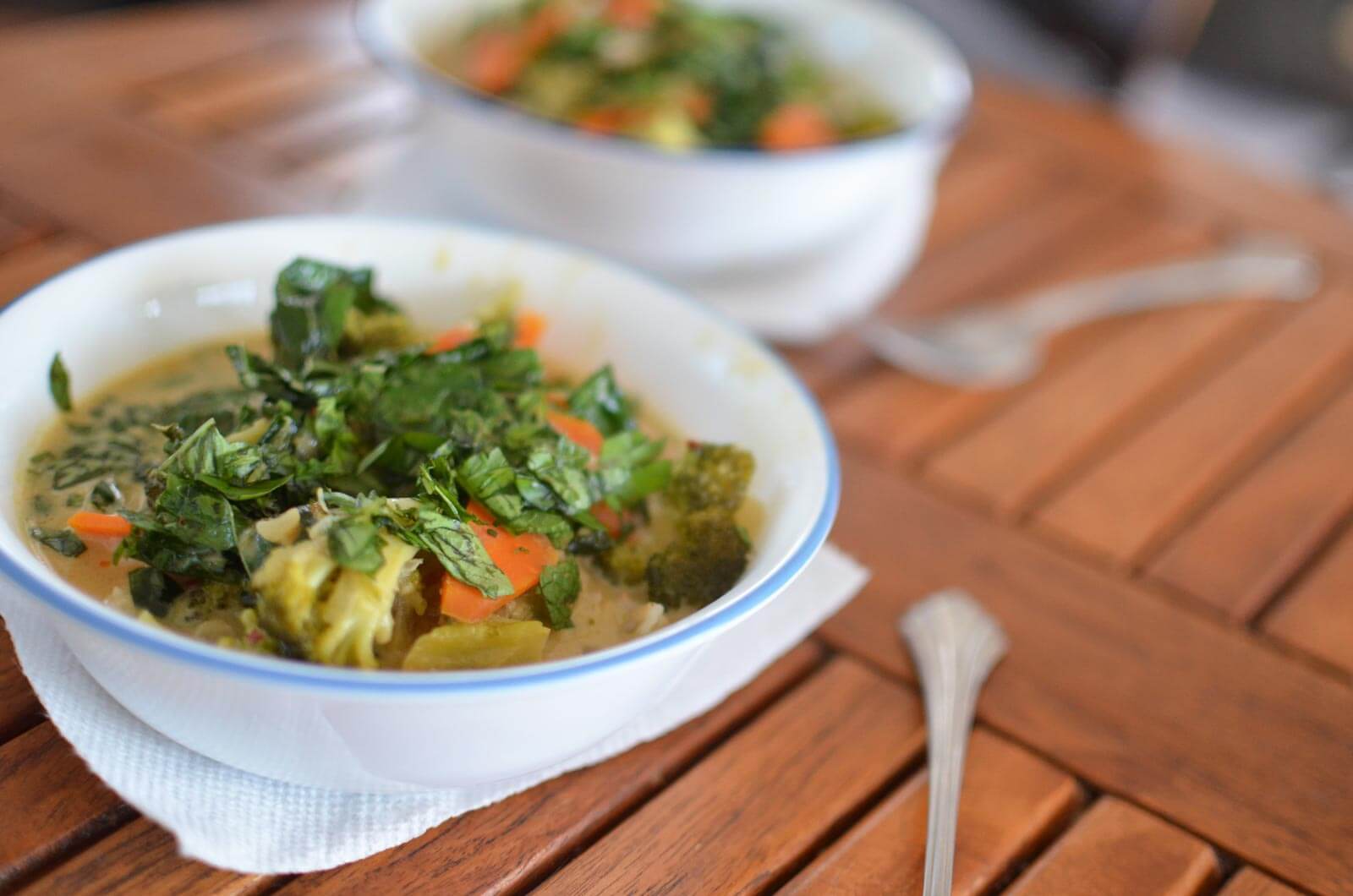 Bowls of Thai green curry on galley dinner table