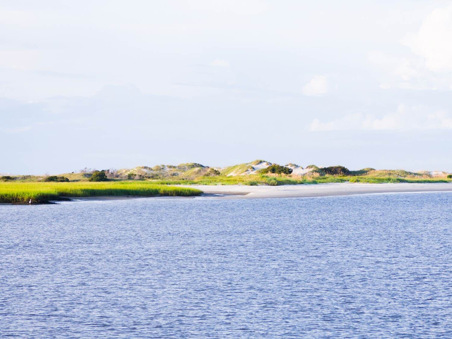 simple view of blue water and sand dunes