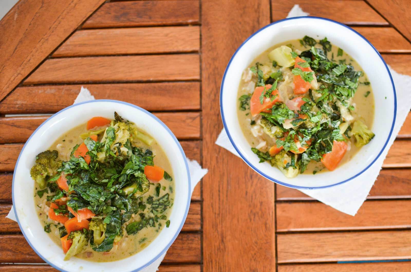 two bowls of green curry on cockpit table