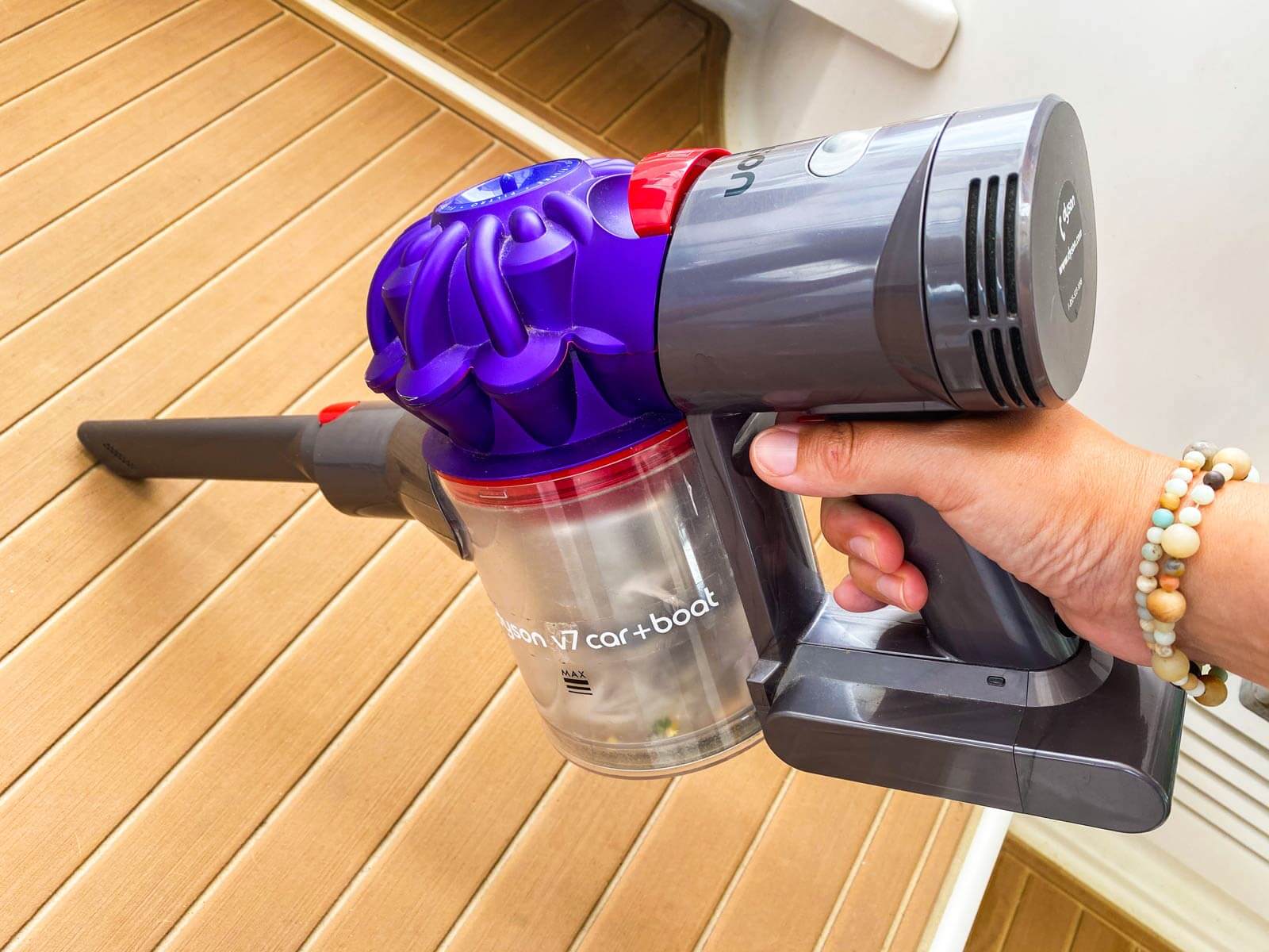 person vacuuming cockpit floor lining