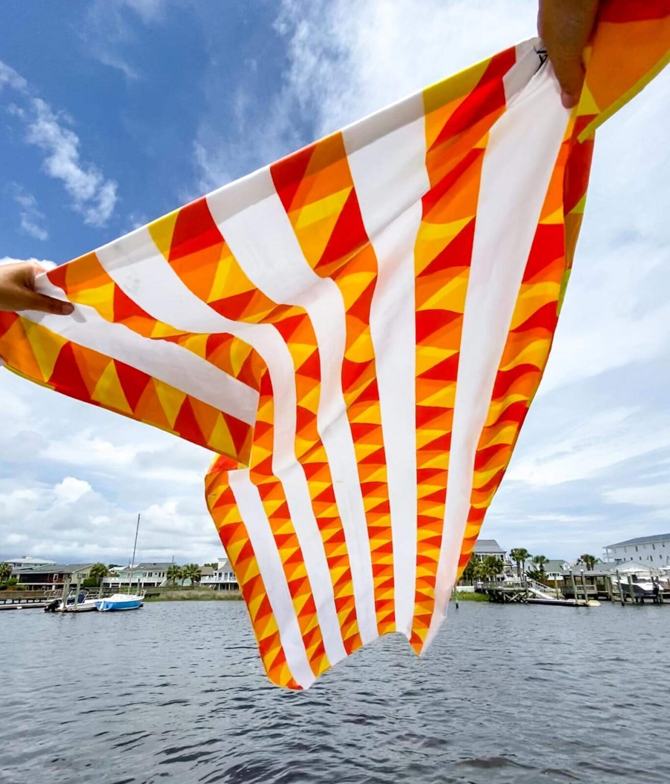 towel held out in the breeze over the water