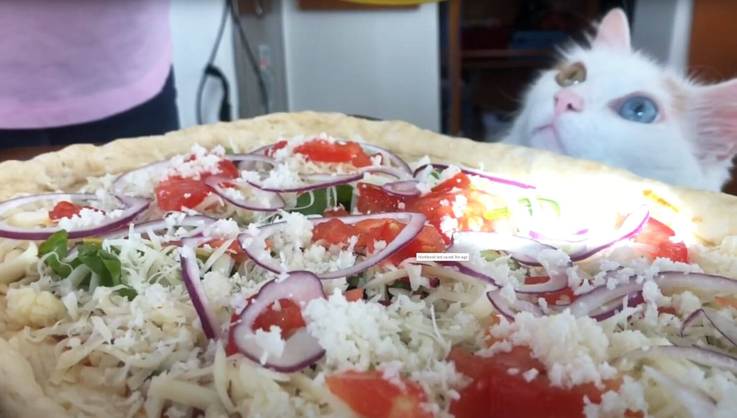 adding toppings to pizza