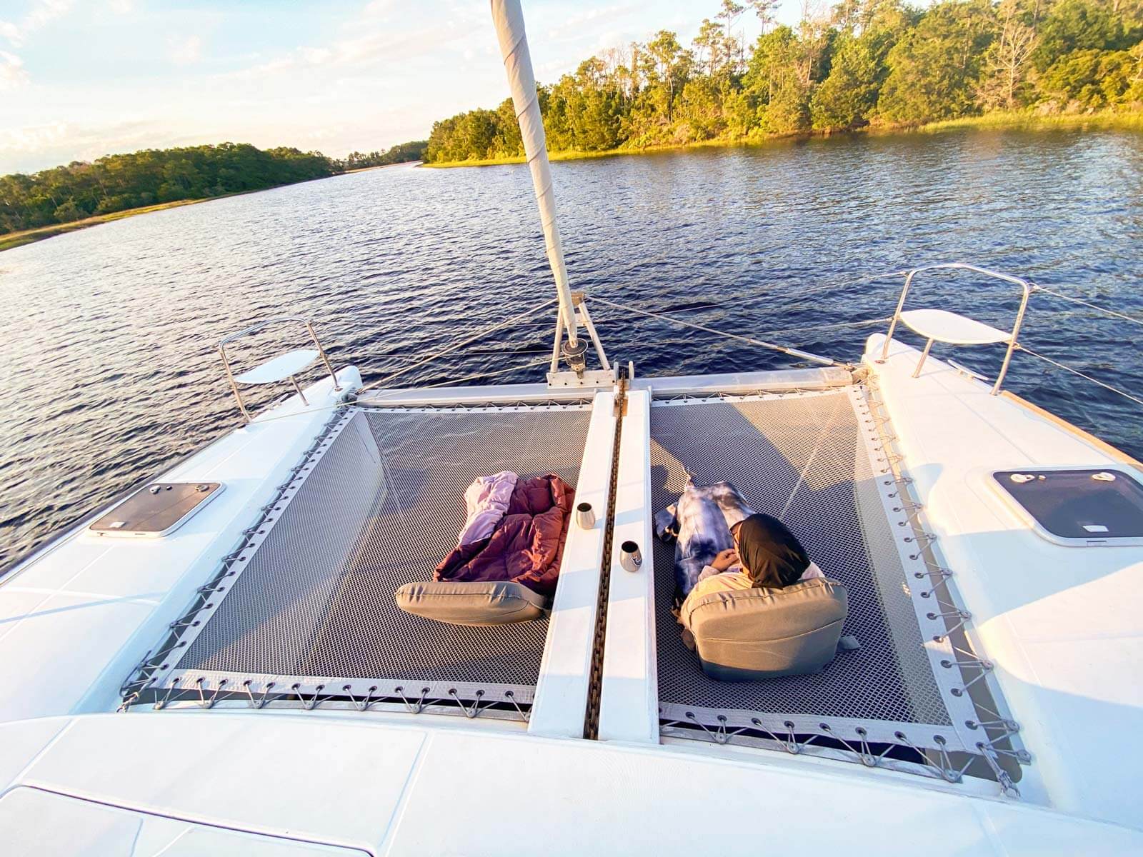 two folding chairs setup on trampoline of catamaran