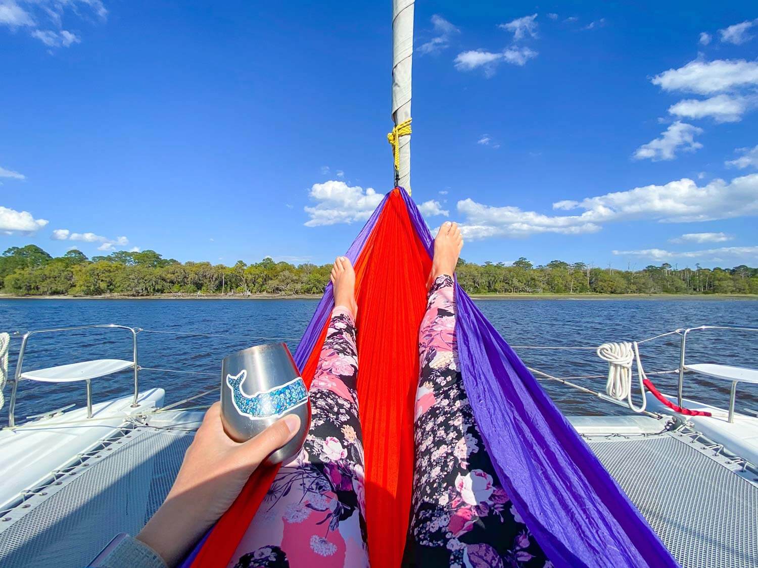 Woman wearing swim leggings in hammock.