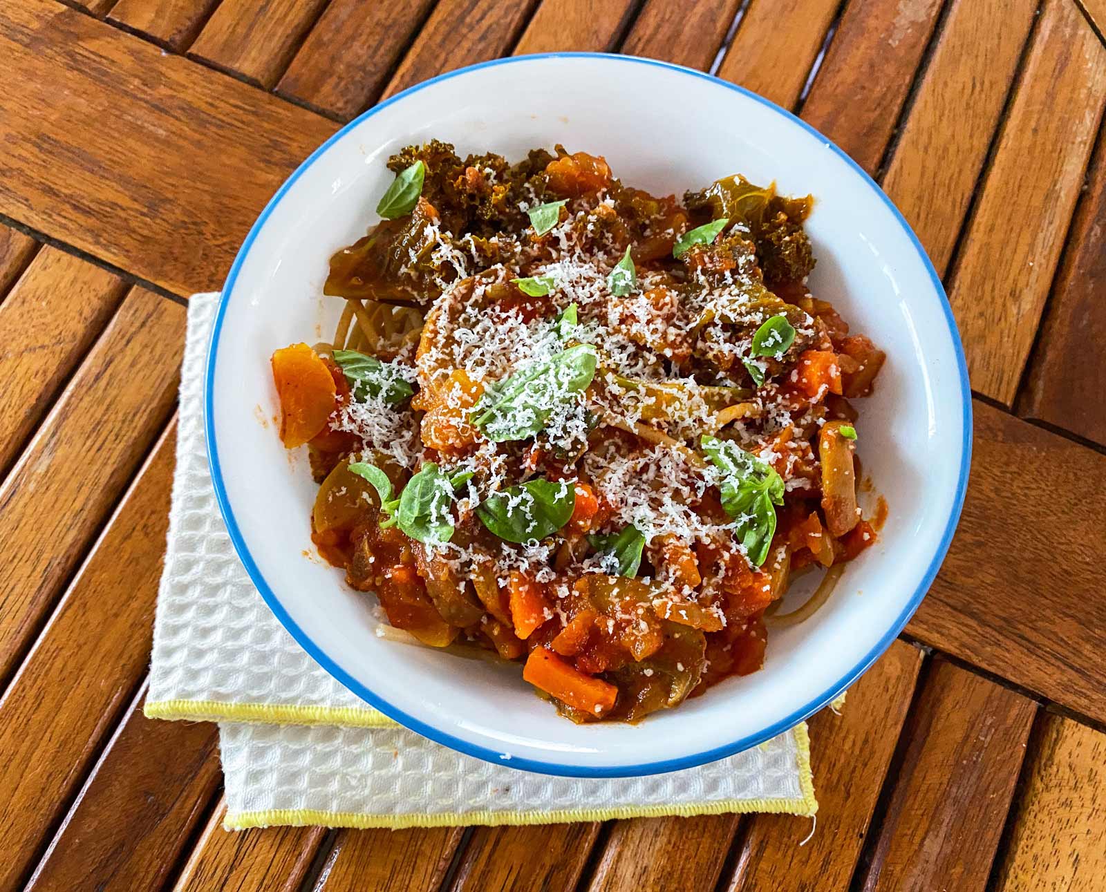 vegetable spaghetti in a bowl with cheese on top