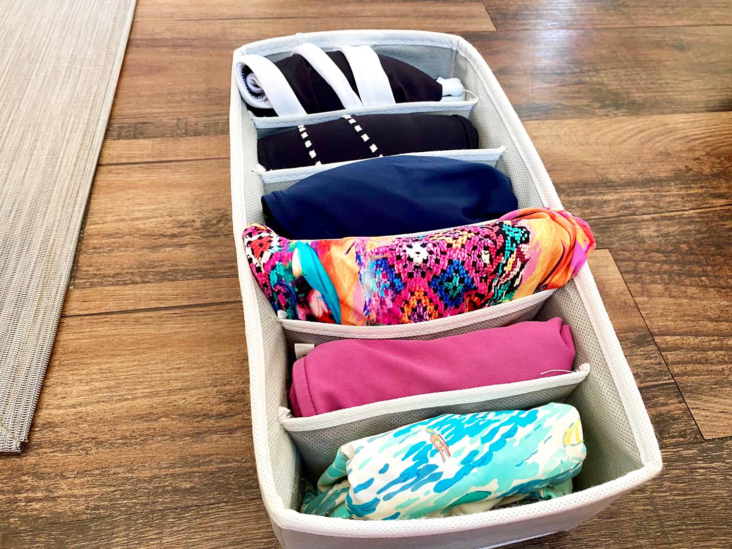 bathing suits folded and stored in tee storage bin