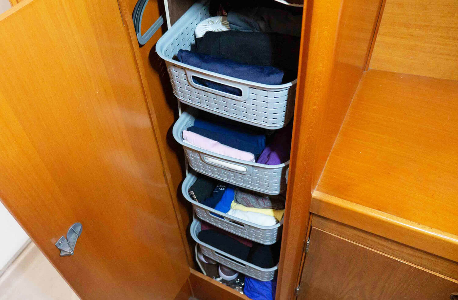 clothing storage baskets hanging in wardrobe