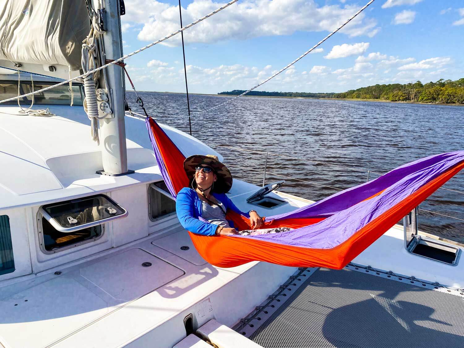 woman in hammock on sailing catamaran