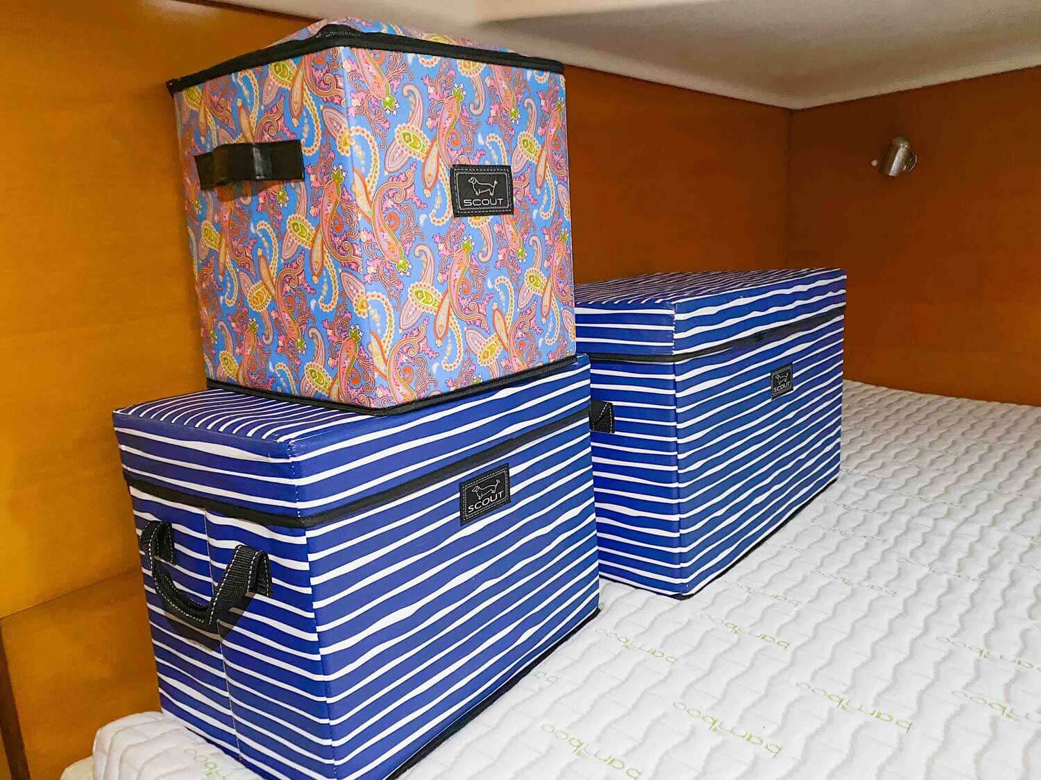 large storage bins on bed in cabin