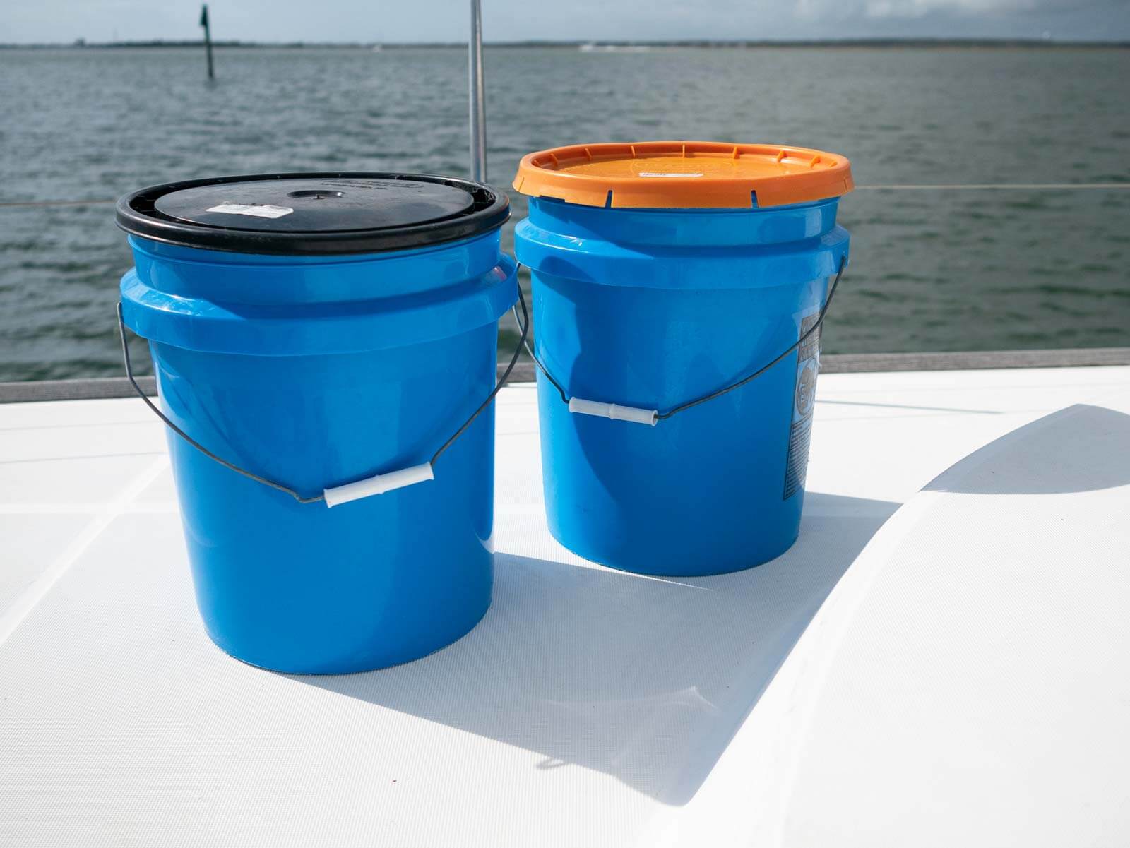 5-gallon storage buckets on boat deck