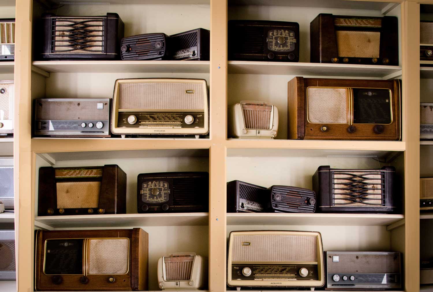 Collection of old radios on shelves