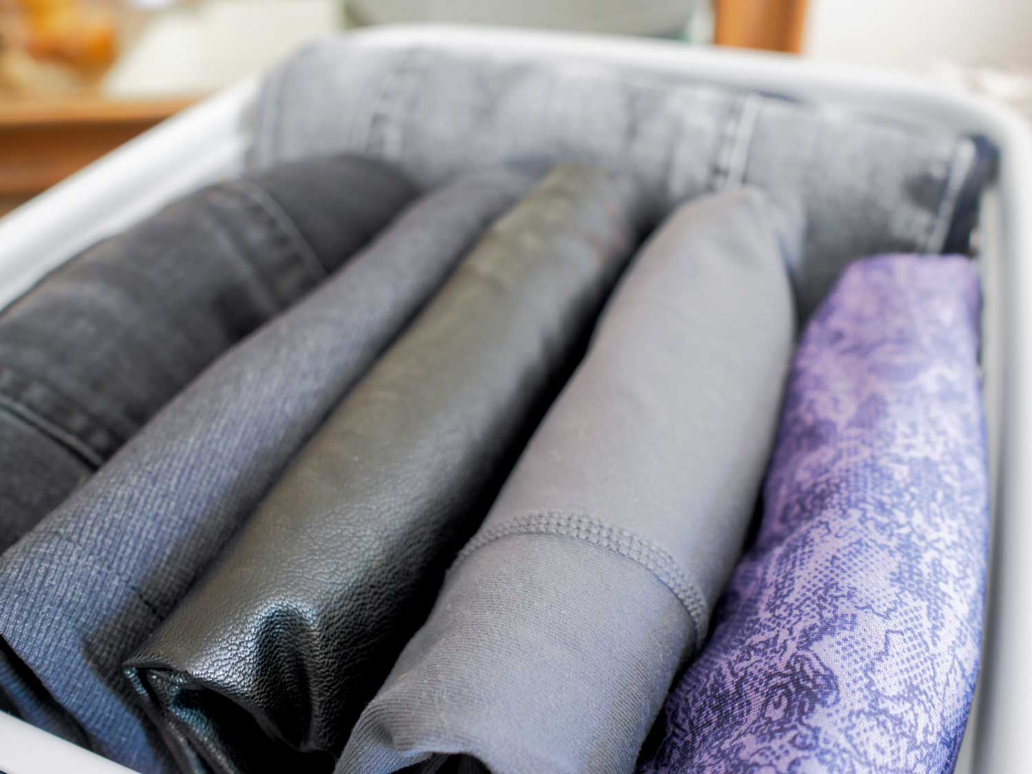 Pants folded neatly in storage basket