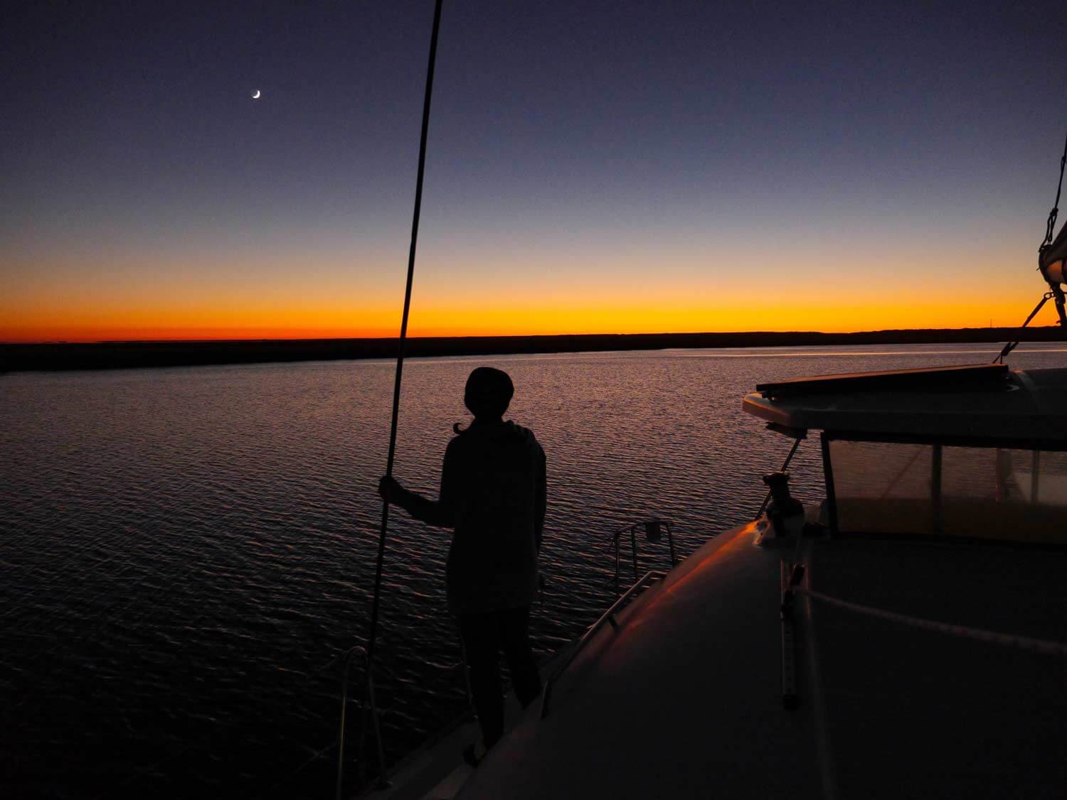 Silhouette at twilight on anchor on a sailboat