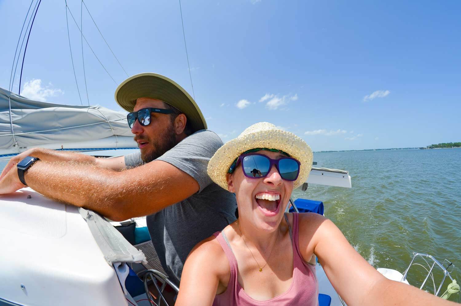 Couple at the helm on a sailboat