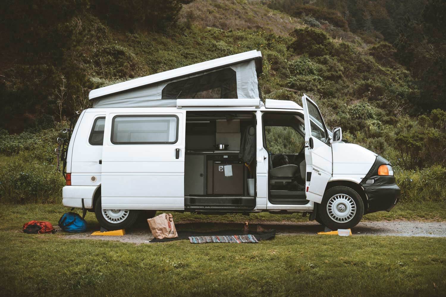 Van with doors open and gear around the outside