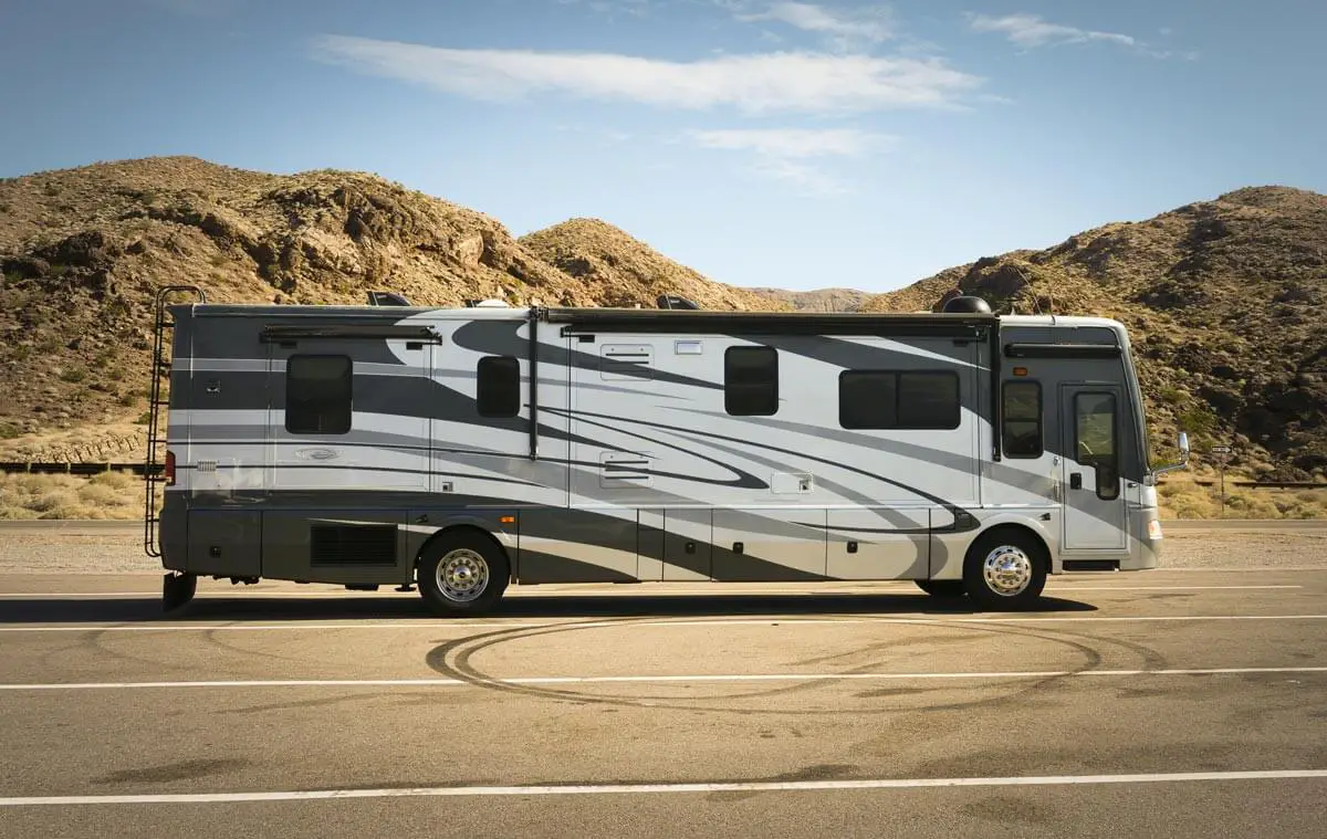 Class A RV motorhome on the road in the high desert.