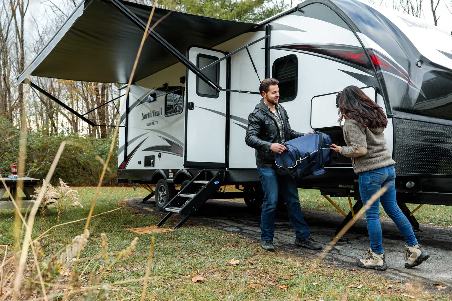 RVers setting up camp outside their travel trailer