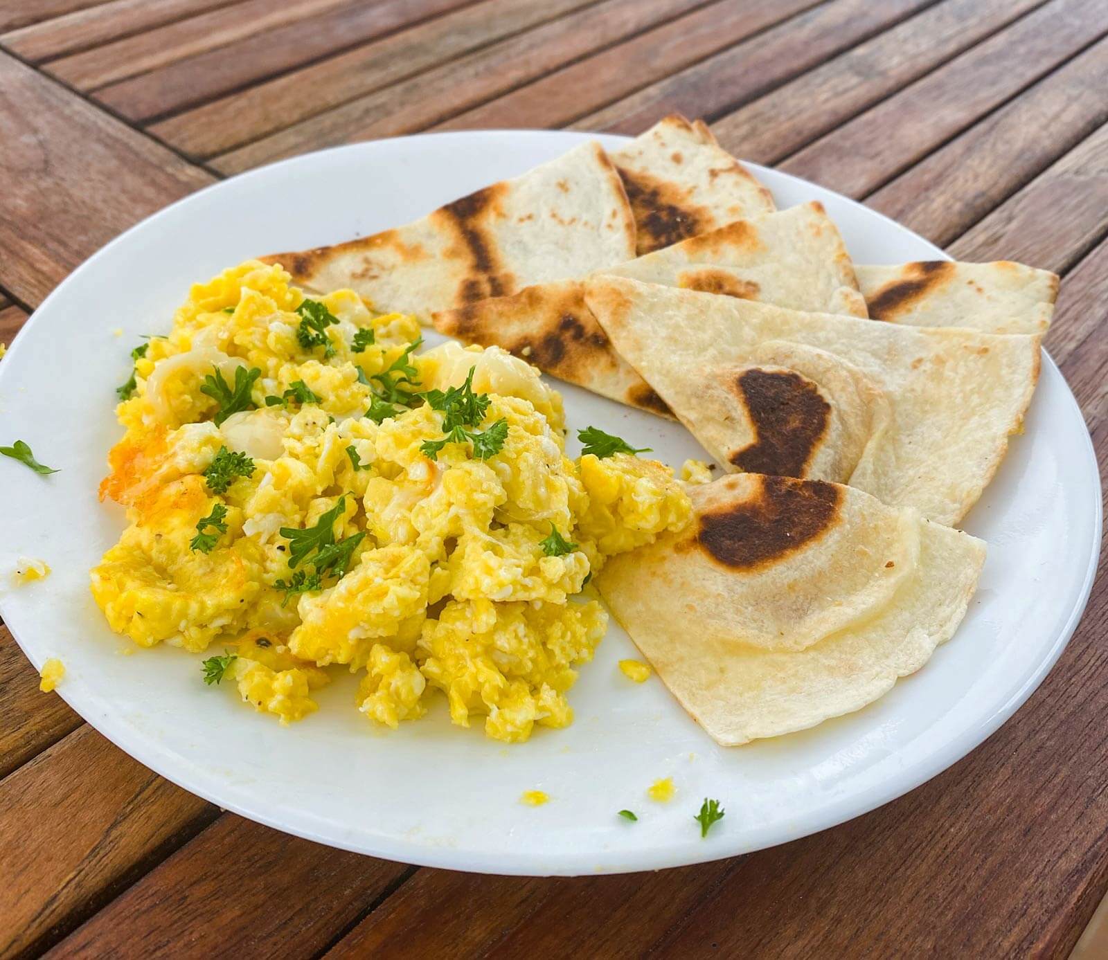 scrambled eggs with cheese and parsley and toasted tortilla wedges