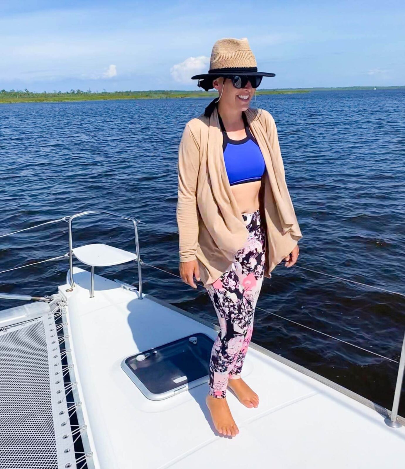 Sailing woman on bow of boat with wearing ideal sailing clothes.