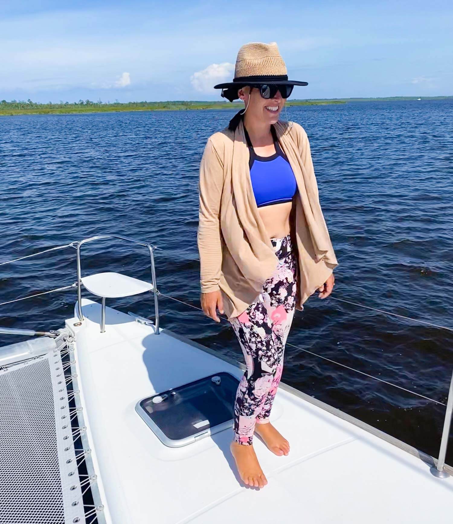 sailing lady on bow of boat with wearing sailing friendly clothes