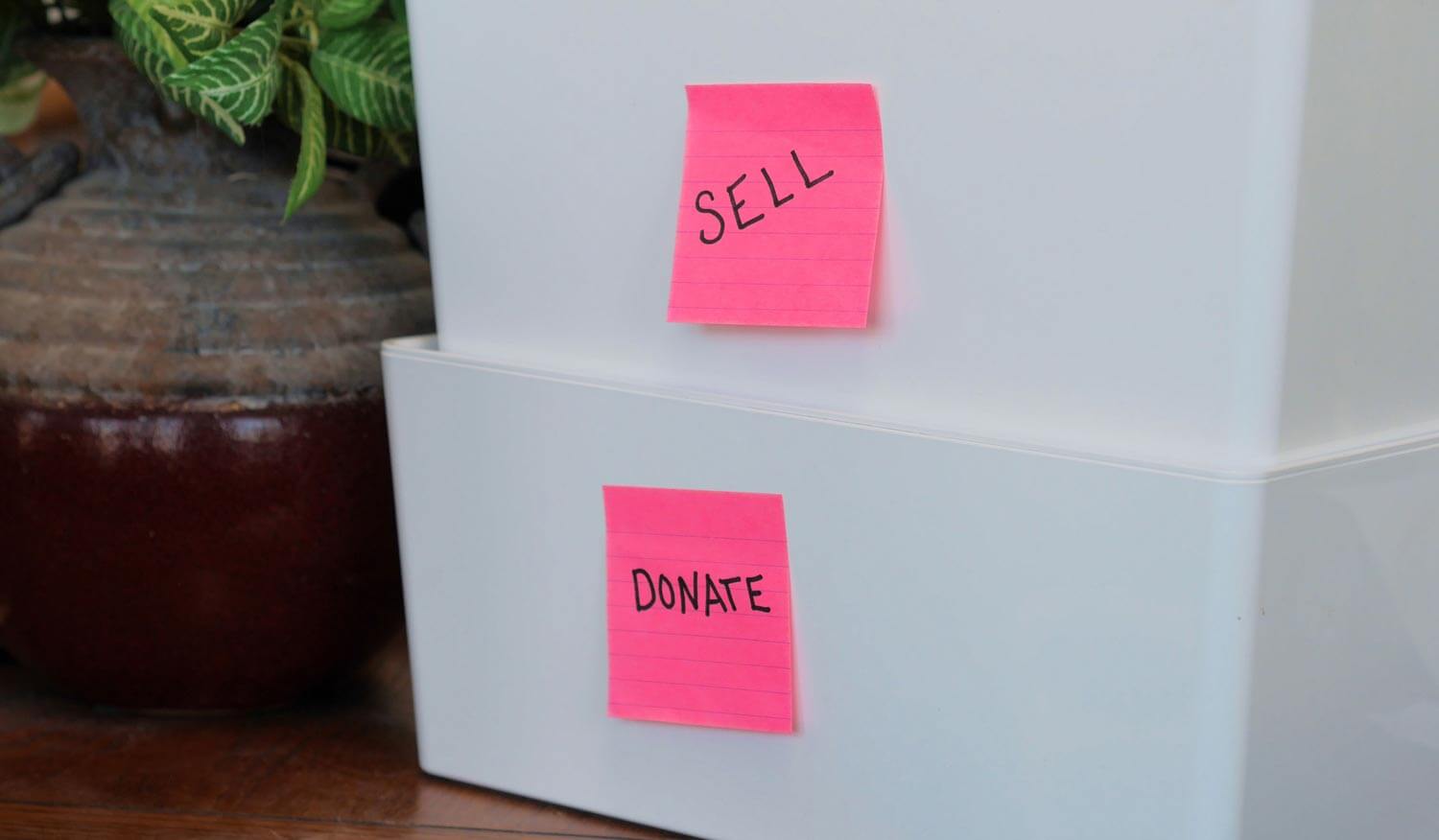 bins with 'sell' and 'donate' sticky notes attached