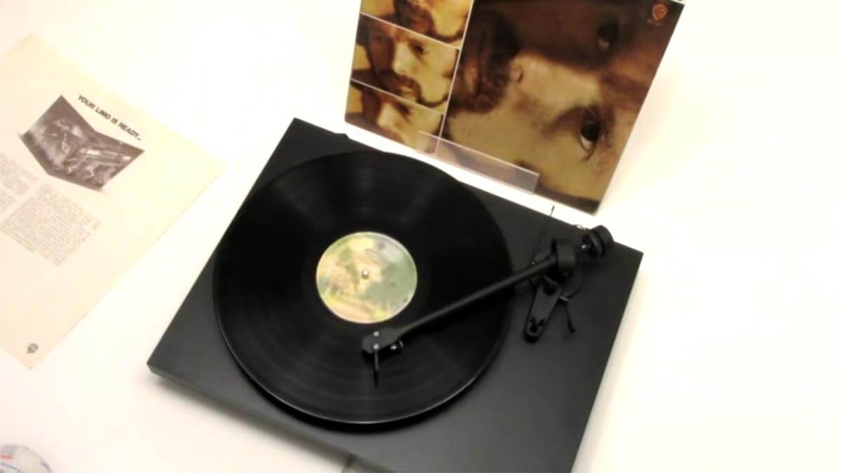 Image of Van Morrison album on record player with album cover in the background.