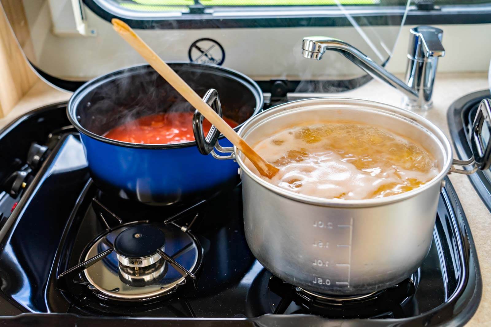 two pots cooking on an RV stove