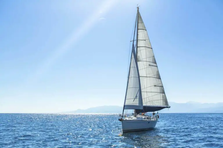 Monohull sailboat with sails up on the ocean