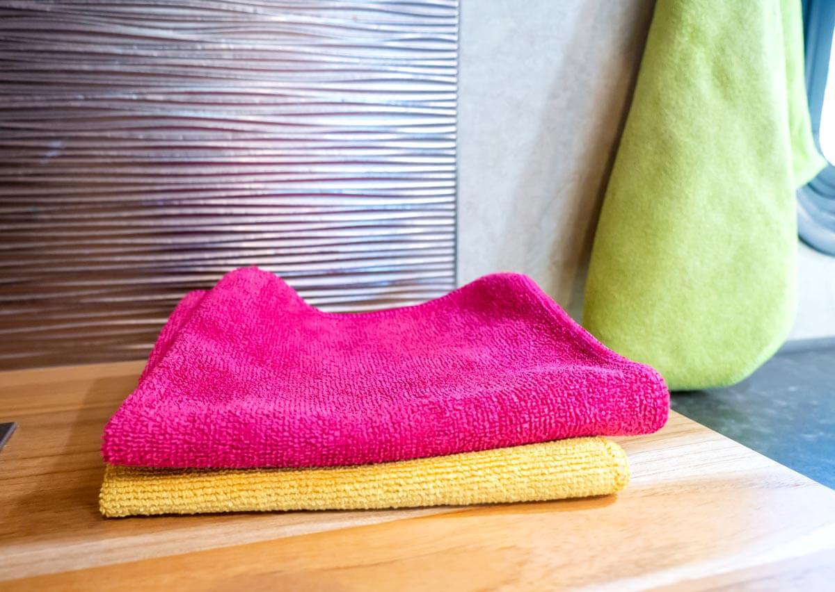 E-cloths cleaning towels folded on countertop in an RV kitchen.