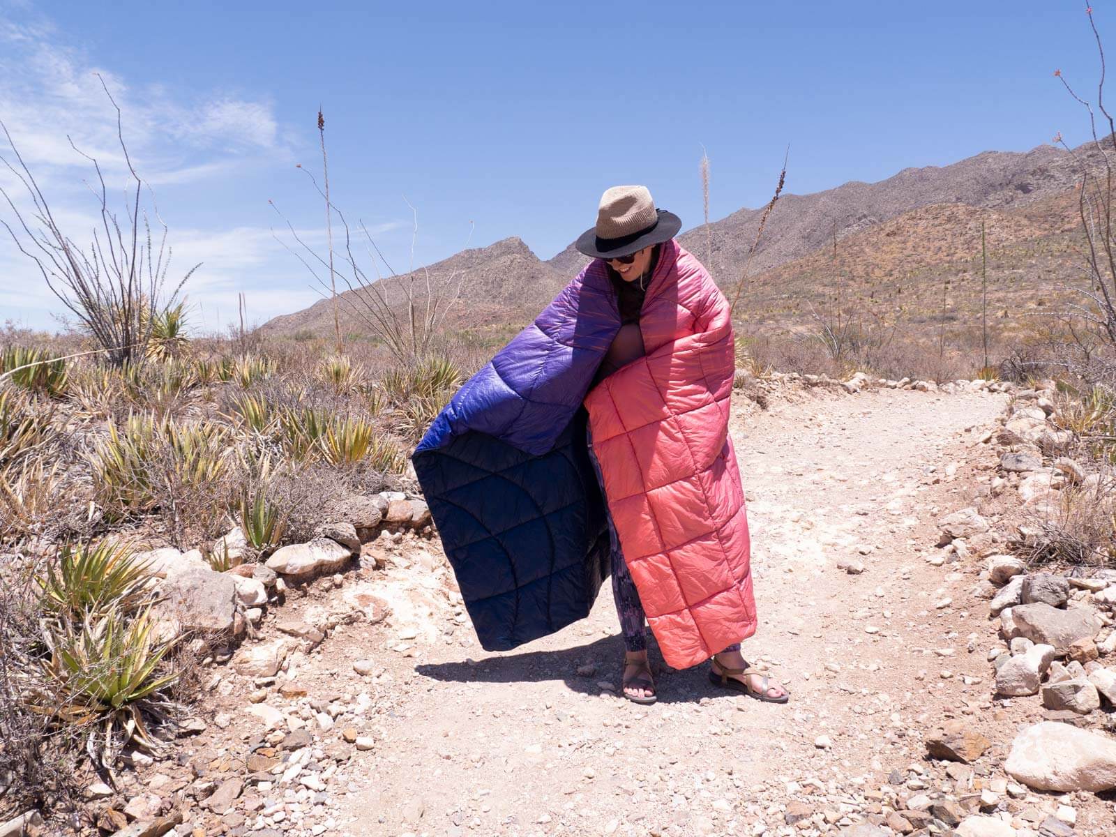 woman wrapped in puffy blanket outside