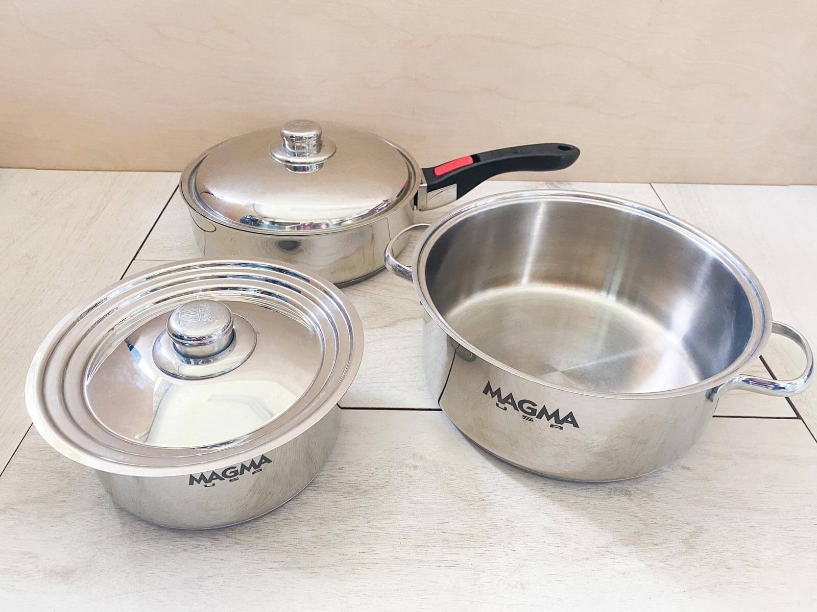 Set of Magma nesting pots with removable handles placed so you can see each piece of the set