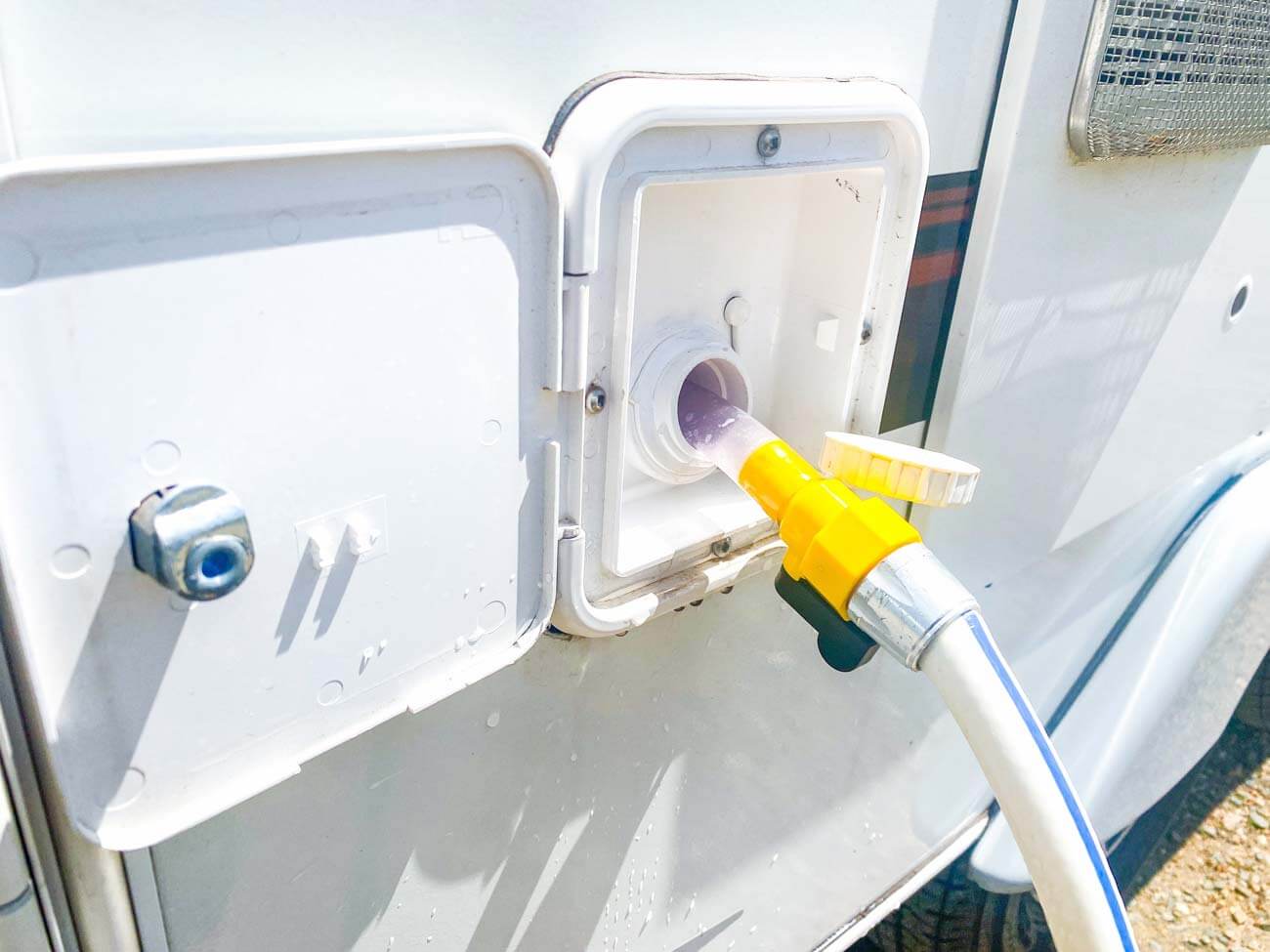 Water hose filling up tank on an RV.