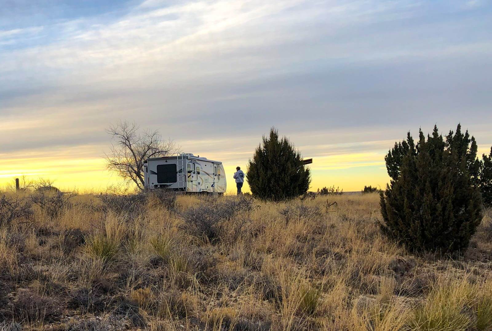 rv camper on a hill at sunset