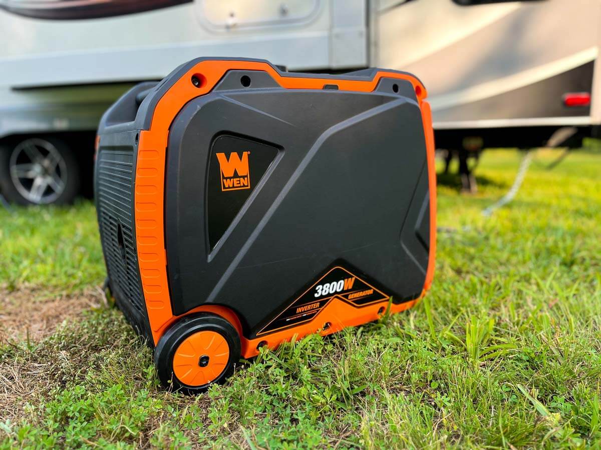 Gas generator in the grass beside an RV travel trailer. 