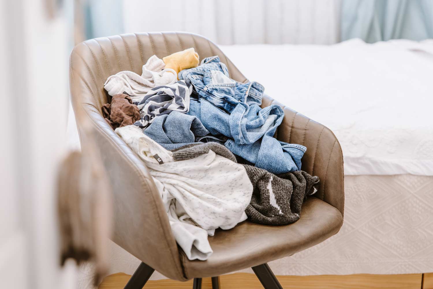 chair with a pile of clothes on top