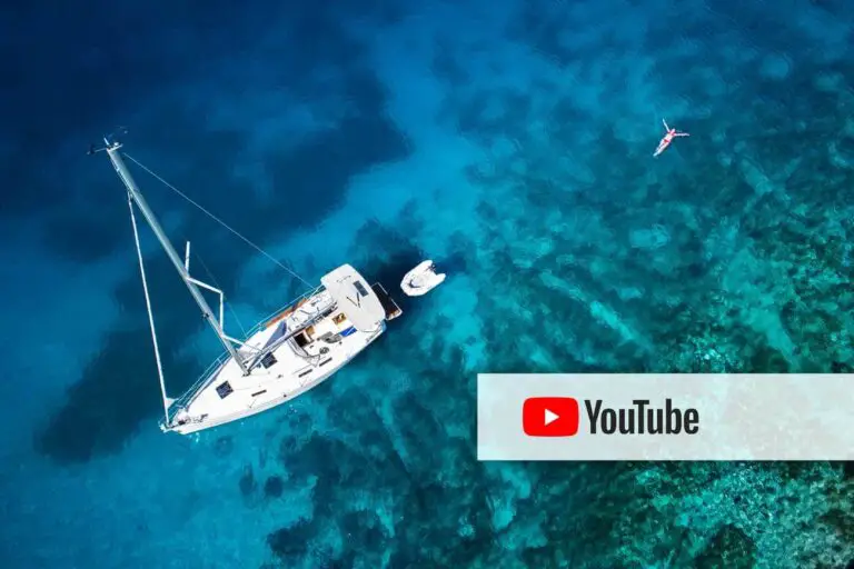 Ariel of sailboat anchored on the shore with YouTube logo overlayed.
