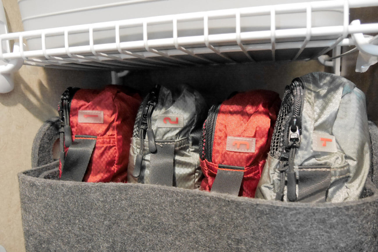 packing cubes organized in felt bin in rv closet